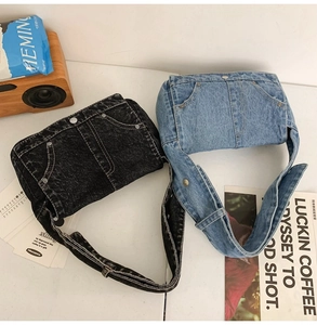 Detailed view of deconstructed denim shoulder bags in vintage blue and dark grey wash