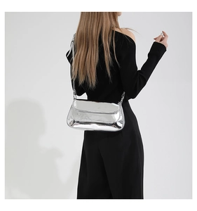 Silver metallic mirror PU leather hobo bag worn by a model in a minimalist Y2K style