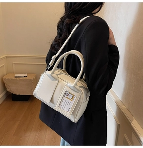 Close-up of a white glossy bowling bag featuring a front card slot and silver hardware