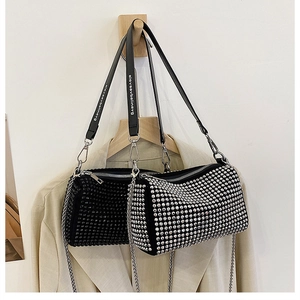 Detail of rhinestone cylindrical bags with wide letter strap and silver chain handles