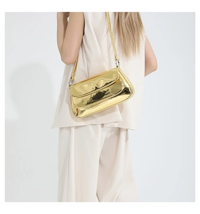 Detailed back view of a glossy gold metallic shoulder bag with slim strap and silver rings