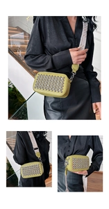Detail of lemon yellow camera bag with silver rhinestones and wide woven strap