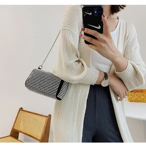 Close-up of sparkling rhinestone evening bag with elegant metal chain shoulder strap