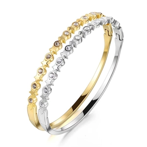 Gold and silver star bangles with round rhinestones in a sleek 45-degree angled view