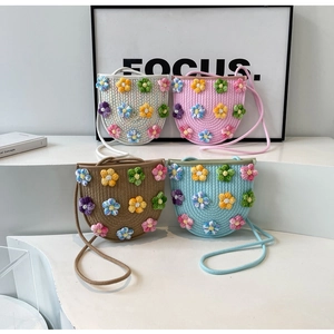 Handwoven floral crossbody bags in multiple pastel colors with decorative crochet flowers