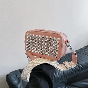Pink crossbody camera bag with sparkling rhinestones and a patterned woven strap