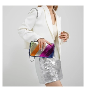 Detail of colorful metallic paneled crossbody bag with silver chain strap on a model