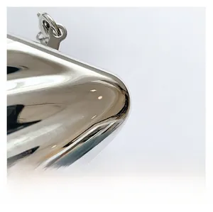 Macro shot of silver mirrored acrylic surface with a precise polished metal clasp detail