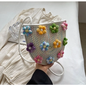 Detailed shot of white hand-woven crossbody bag with vibrant 3D crochet flowers