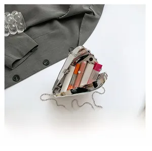 Interior view showing the capacity of a silver heart-shaped mirror acrylic chain bag
