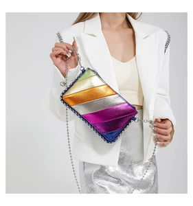 Close-up of vibrant rainbow metallic leather bag with silver studs and chain strap