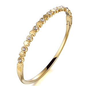 Polished gold heart and clover bangle with sparkling cubic zirconia stones for women