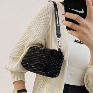 Sparkling black rhinestone cylinder bag with leather shoulder strap and silver hardware