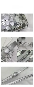 Detail of silver sequin bag showing high-gloss metal hook and smooth zipper closure