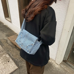 Retro washed denim shoulder bag with high-quality stitching and metal rivet details