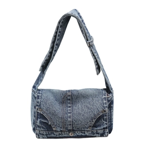 Blue acid wash denim crossbody bag with metal rivets and adjustable wide strap
