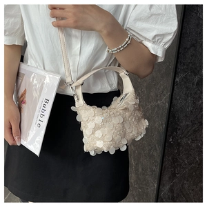 Chic beige sequin underarm bag styled with a white shirt and black skirt