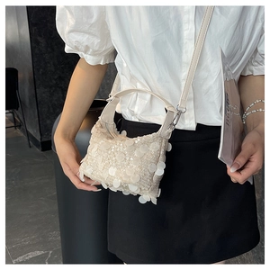 Fashionable cream sequin crossbody bag featuring wavy 3D texture and detachable strap