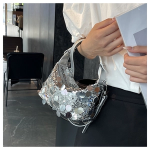 Close-up of stylish silver sequin handbag featuring a metallic strap and zipper closure