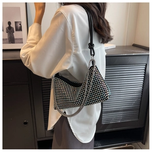 Detail of hobo bag with iridescent rhinestones, silver chain and black leather strap