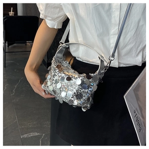 Silver sequin crossbody bag detail showing detachable strap and shiny texture