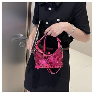 Detail of rose red sequin crossbody bag styled with a professional black dress