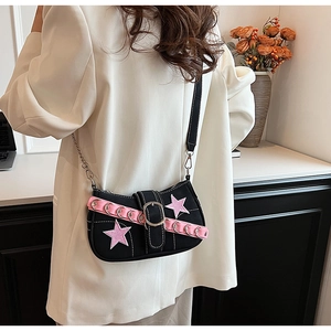 Detail of Y2K style shoulder bag with pink star patch and silver ring buckle strap