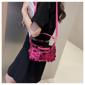 Detail of fuchsia sequin shoulder bag with leather strap and Y2K metallic shimmer effect