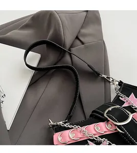 Detail of Y2K shoulder bag featuring pink star embroidery and silver punk chain accents