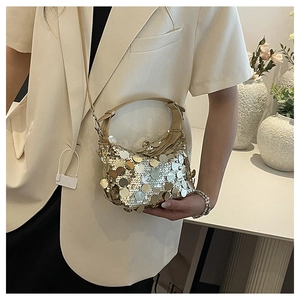 Detailed close-up of a sparkling sequin handbag with gold and silver metallic discs