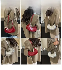 Detail of burgundy and silver crescent shoulder bags with elegant pearl tassel charms