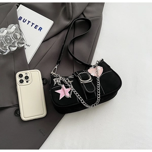 Y2K street style black shoulder bag with pink star patch and silver chain detail