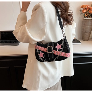 Close-up of Y2K black shoulder bag featuring pink star patches and metallic chain detail