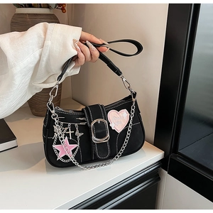 Detailed view of black Y2K shoulder bag with pink star patches and silver buckle