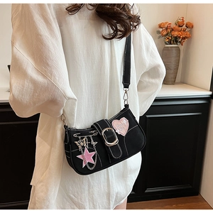Detail of black canvas Y2K shoulder bag featuring pink heart embroidery and silver chains