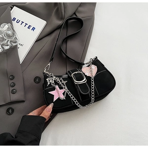 Detail of Y2K black shoulder bag with pink sequin stars and a silver metal chain strap