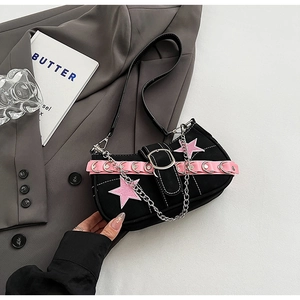 Detailed shot of Y2K black canvas shoulder bag with pink stars and metal eyelet straps