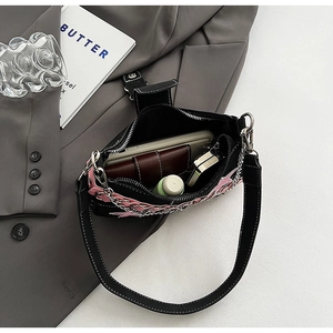 Internal view of black Y2K shoulder bag showing space for phone and makeup accessories