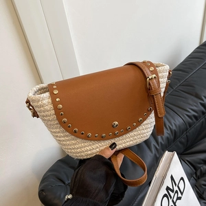 Women's hand-held woven beach crossbody bag with brown leather flap and rivet accents