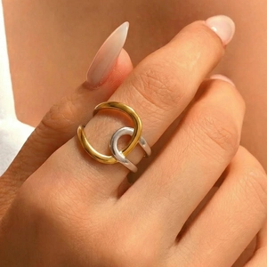 Minimalist geometric two-tone stainless steel ring worn on hand with golden and silver circles