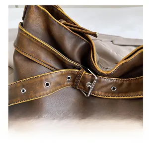 Detailed macro shot of vintage brown leather texture with silver buckle and yellow stitching