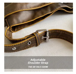 Detail of adjustable strap on vintage brown leather bag with silver metal buckle and eyelets