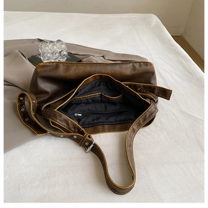 Detail shot of the large vintage brown shoulder bag showing internal pockets and lining