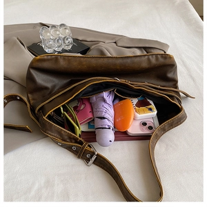 Spacious interior of brown faux leather hobo bag showing capacity for daily essentials