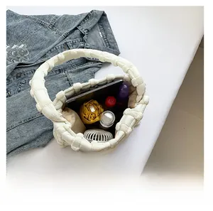 Interior view showing large capacity of the white bubble puffer bag for daily items