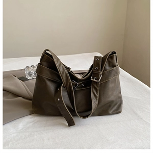 Detailed view of spacious olive brown leather tote bag with vintage decorative buckle