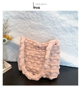 Pink quilted bubble tote bag featuring a textured puffy grid pattern and magnetic snap