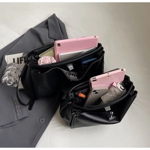 Top-down view of black leather tote bag showing large capacity for tablet and daily items