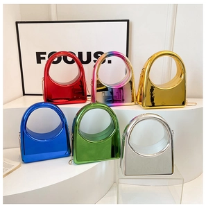 Detailed view of candy-colored acrylic evening bags with circular handles and metal chains