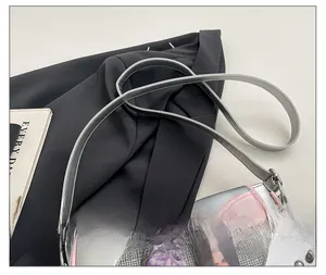 Detail of silver leather ita bag with clear window, pink edges and adjustable strap